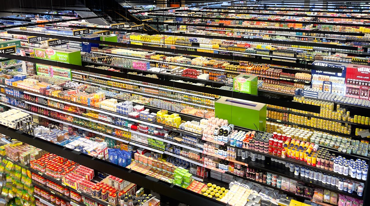 Aerial view of supermarket aisles filled with colorful products and packaging.